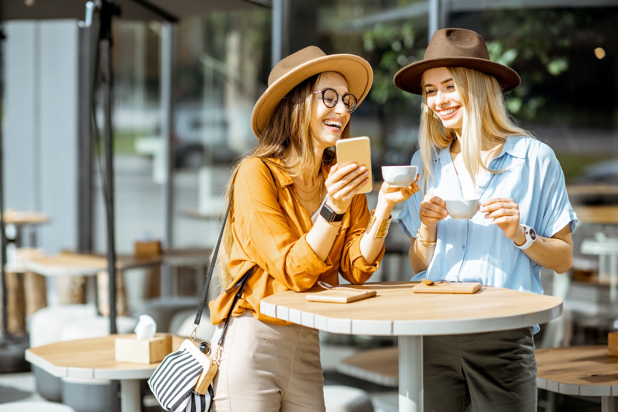 Girlfriends spending time together on a cafe terrace